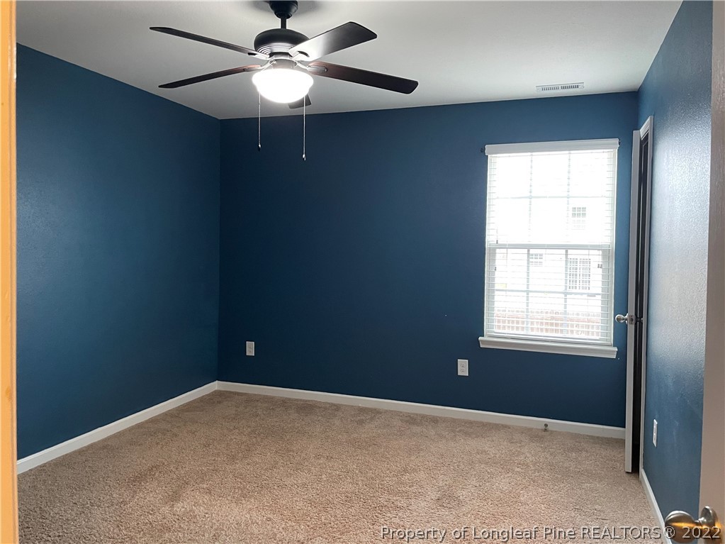 251 Botanical Court Bunnlevel, NC 28323 - Photo 14 of 16 en empty room with windows and fan