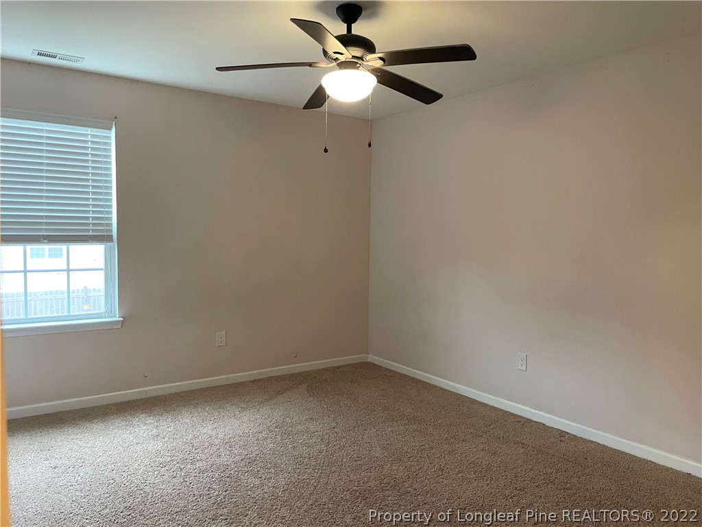251 Botanical Court Bunnlevel, NC 28323 - Photo 16 of 16 an empty room with a window and a fan