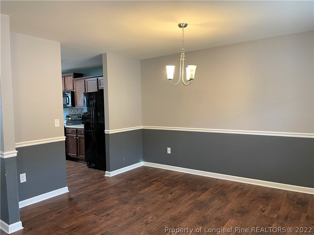 251 Botanical Court Bunnlevel, NC 28323 - Photo 2 of 16 an empty room with wooden floor