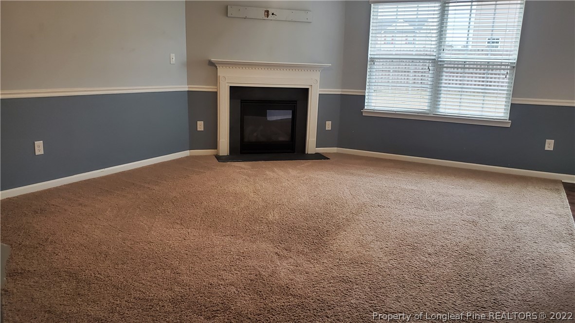 251 Botanical Court Bunnlevel, NC 28323 - Photo 3 of 16 a view of empty room with a fireplace