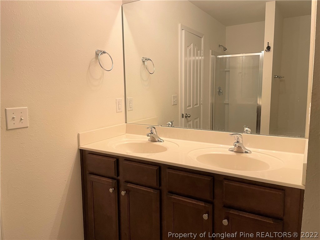 251 Botanical Court Bunnlevel, NC 28323 - Photo 8 of 16 a bathroom with a sink and a mirror