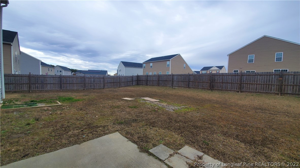 251 Botanical Court Bunnlevel, NC 28323 - Photo 10 of 16 a view of a yard with a wooden fence