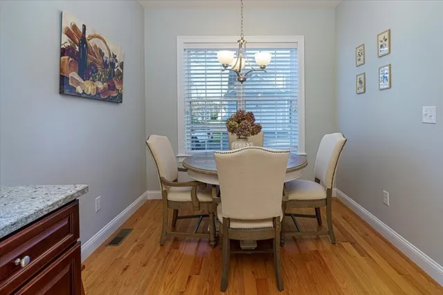 a view of a dining room with furniture wooden floor and a chandelier