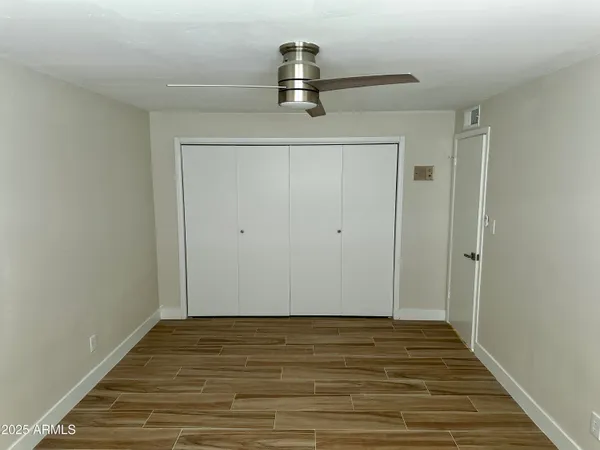 a view of empty room with wooden floor