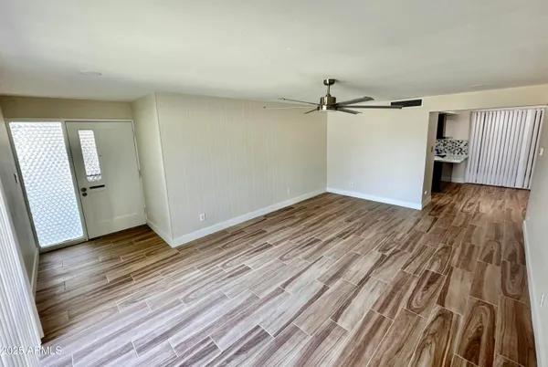 wooden floor in an empty room with a window