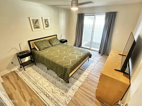 a bedroom with a bed and wooden floor