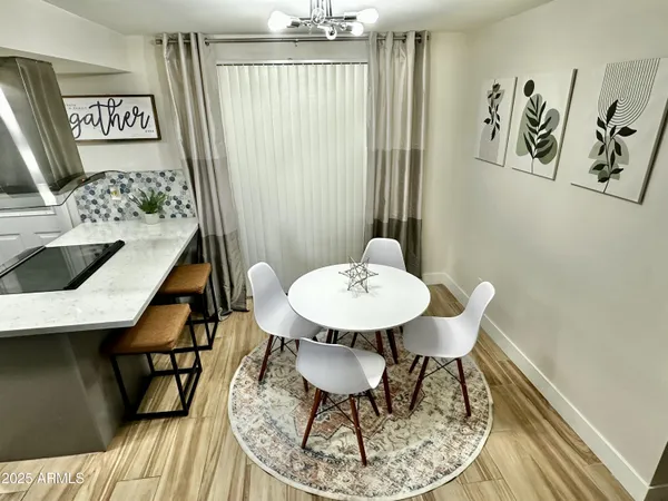 a view of a dining room with furniture and wooden floor