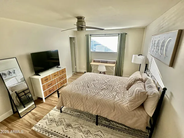 a bedroom with a bed and flat screen tv