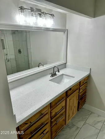 a bathroom with a sink and a mirror