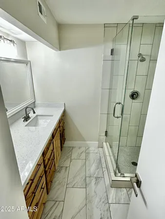 a bathroom with a sink and mirror