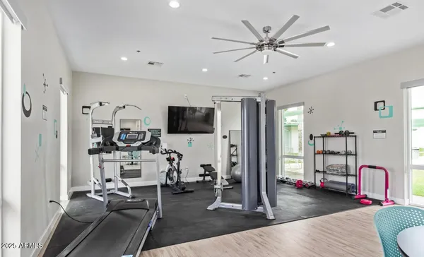 a living room with furniture a flat screen tv and white walls