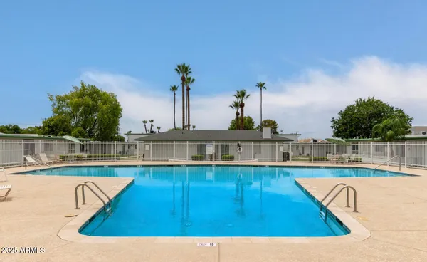 a view of swimming pool with outdoor seating and plants
