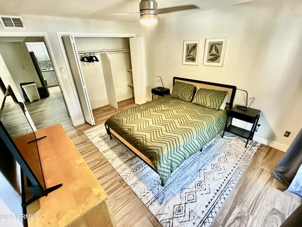 a bedroom with a bed and wooden floor