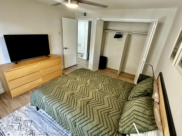 a bedroom with a bed and a flat screen tv