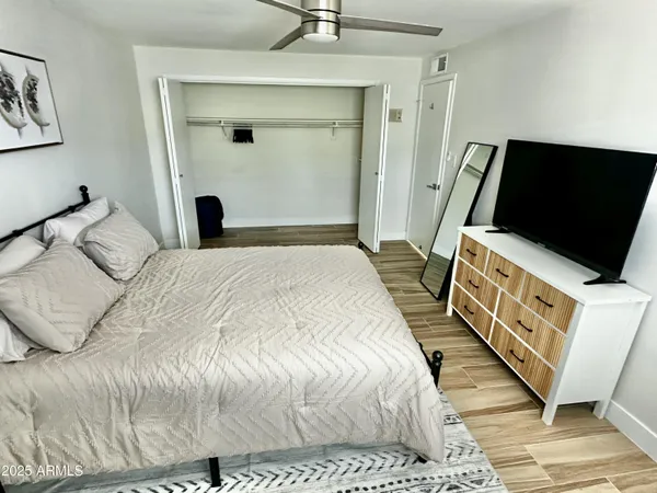 a bedroom with a bed and a flat screen tv