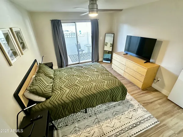 a bedroom with a bed and wooden floor