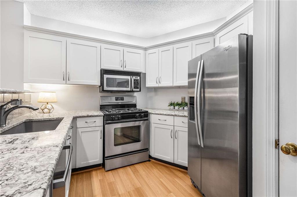 490 Sherman Way Decatur, GA 30033 - Photo 13 of 44 a kitchen with a refrigerator sink and stove