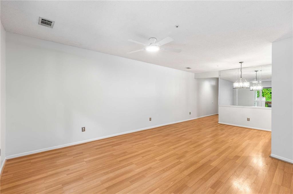 490 Sherman Way Decatur, GA 30033 - Photo 20 of 44 a view of an empty room with wooden floor and a window