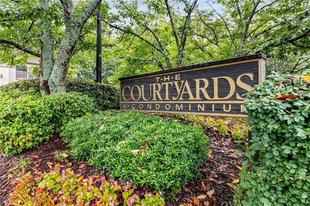 a sign broad in front of flowers