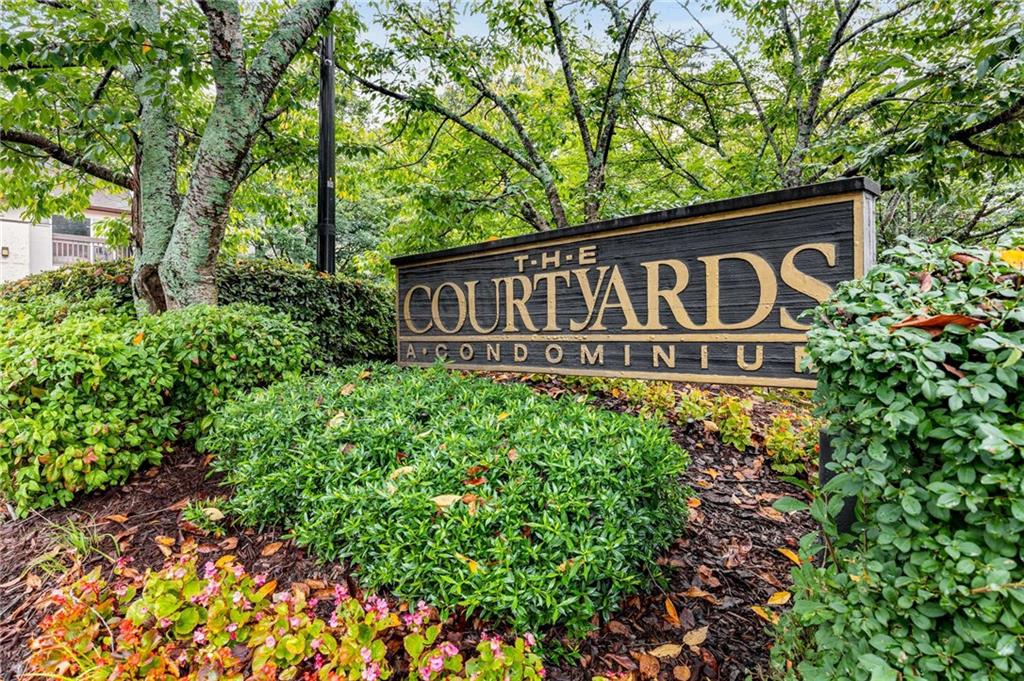 490 Sherman Way Decatur, GA 30033 - Photo 2 of 44 a sign broad in front of flowers