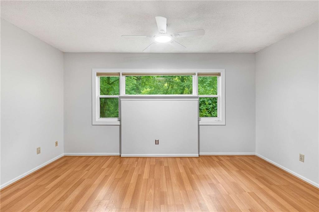 490 Sherman Way Decatur, GA 30033 - Photo 22 of 44 an empty room with wooden floor and windows