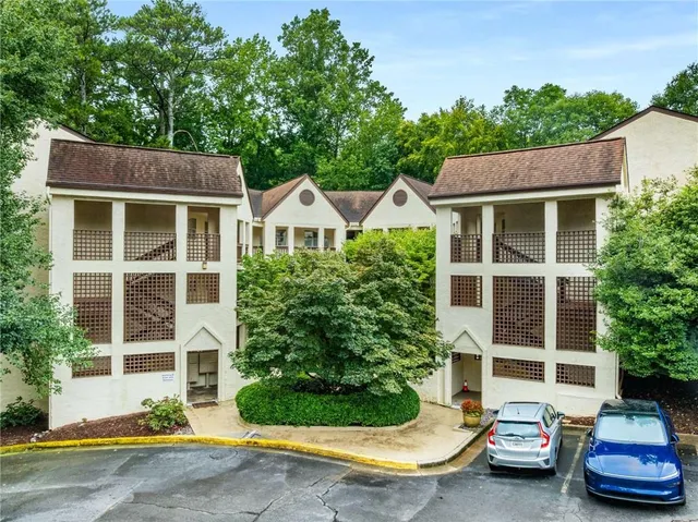a view of a car park in front of a house