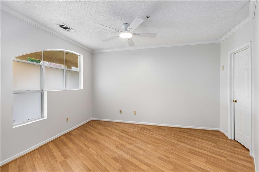 490 Sherman Way Decatur, GA 30033 - Photo 32 of 44 an empty room with wooden floor and windows
