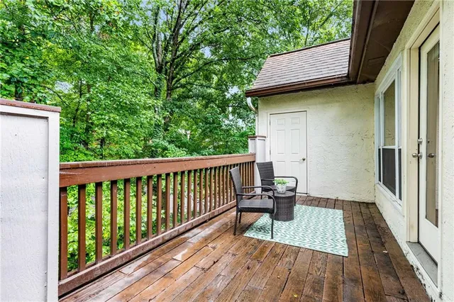 a view of balcony with wooden floor and outdoor seating