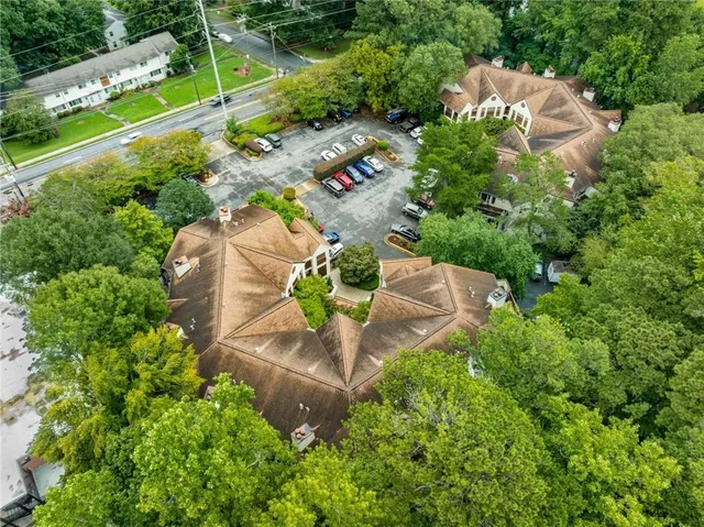 an aerial view of a house with a yard and lake view