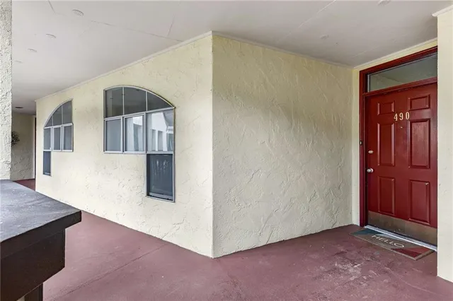 a view of a hallway with entryway wooden floor and cabinet