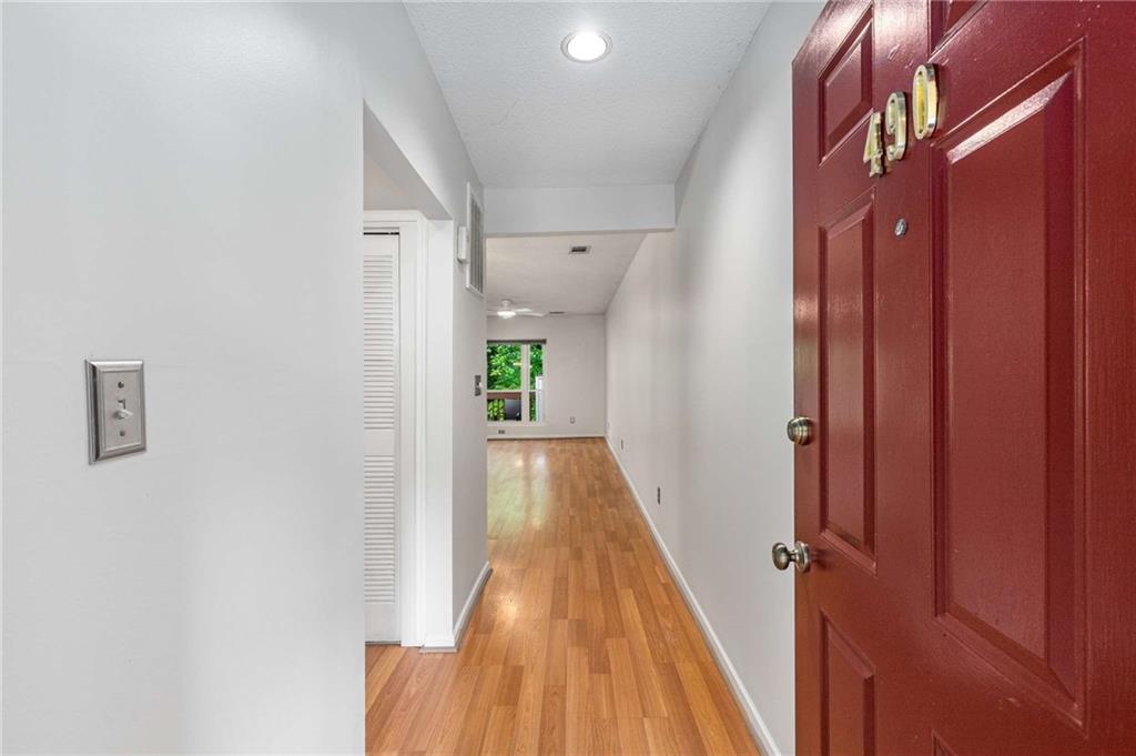490 Sherman Way Decatur, GA 30033 - Photo 7 of 44 a view of a hallway with wooden floor and staircase