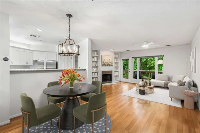 a living room with fireplace furniture and a large window