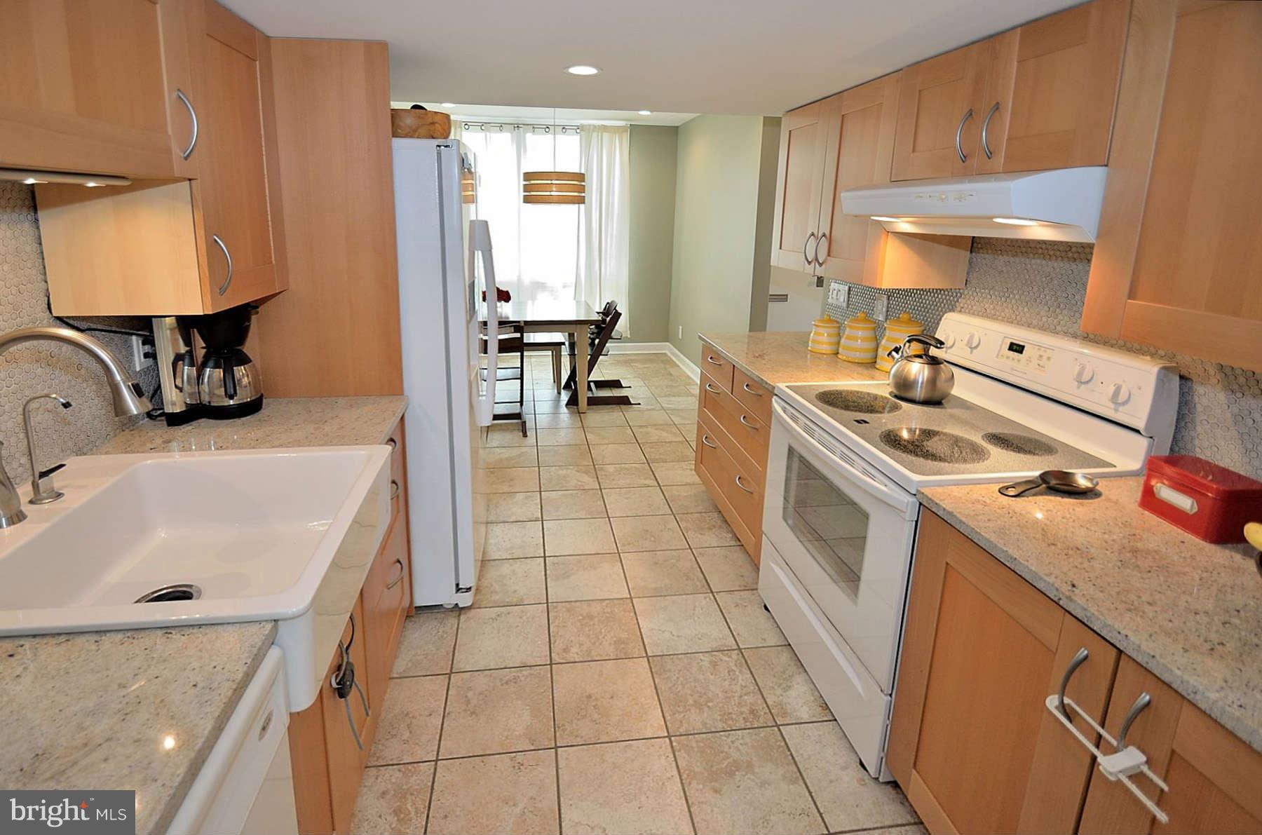 1628 Chimney House Road, Unit 1628 Reston, VA 20190 - Photo 6 of 13 a kitchen with a sink a stove and a refrigerator