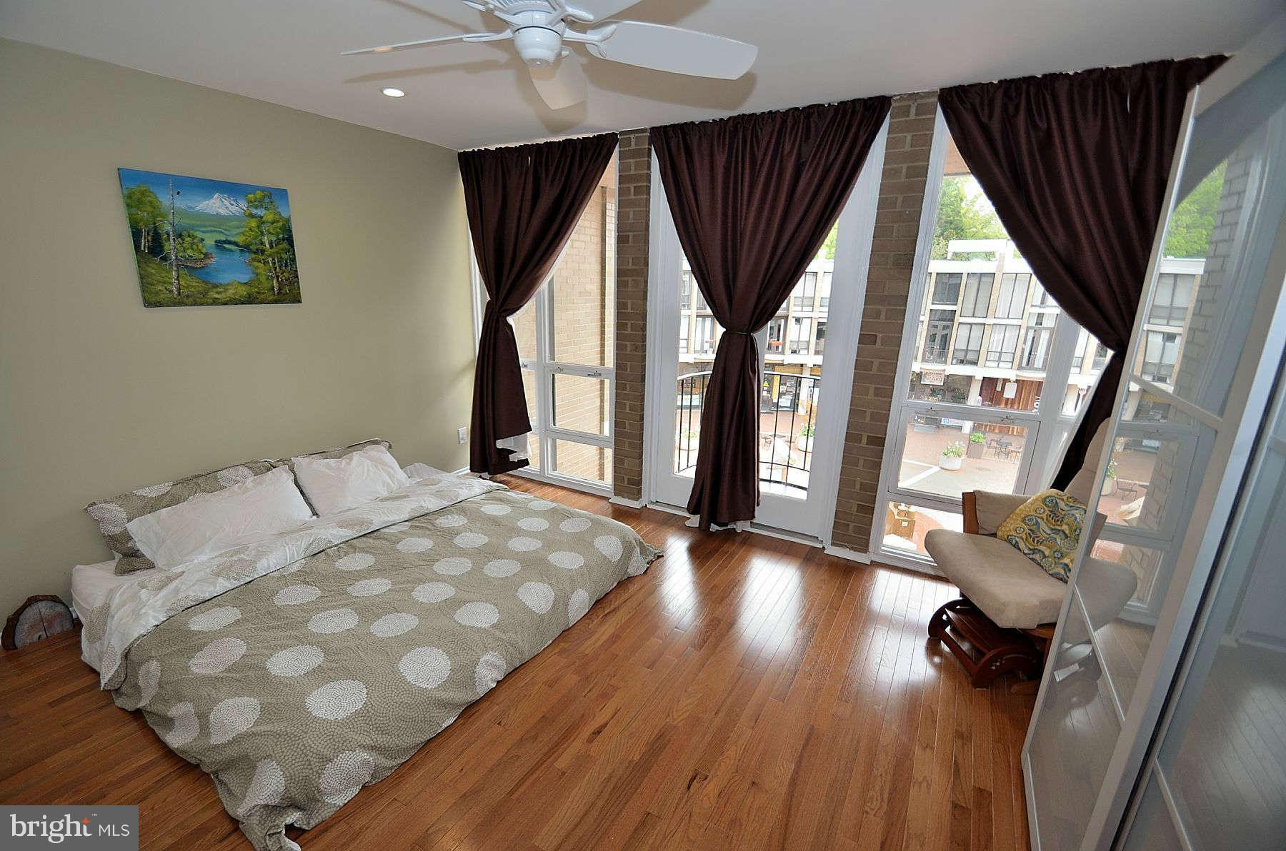 1628 Chimney House Road, Unit 1628 Reston, VA 20190 - Photo 9 of 13 a bed room with a bed and a large window