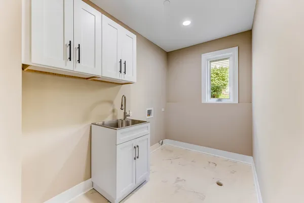 a kitchen with white cabinets and a sink