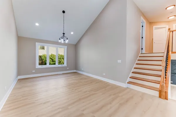 a view of a room with wooden floor and window