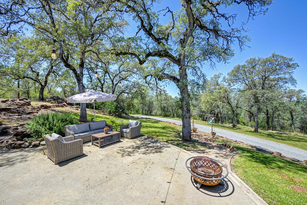3154 Twin K Road Pilot Hill, CA 95664 - Photo 67 of 89 a view of a backyard with table and chairs under an umbrella