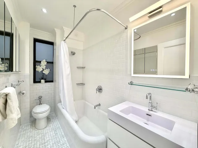 a spacious bedroom with a bed and glass window