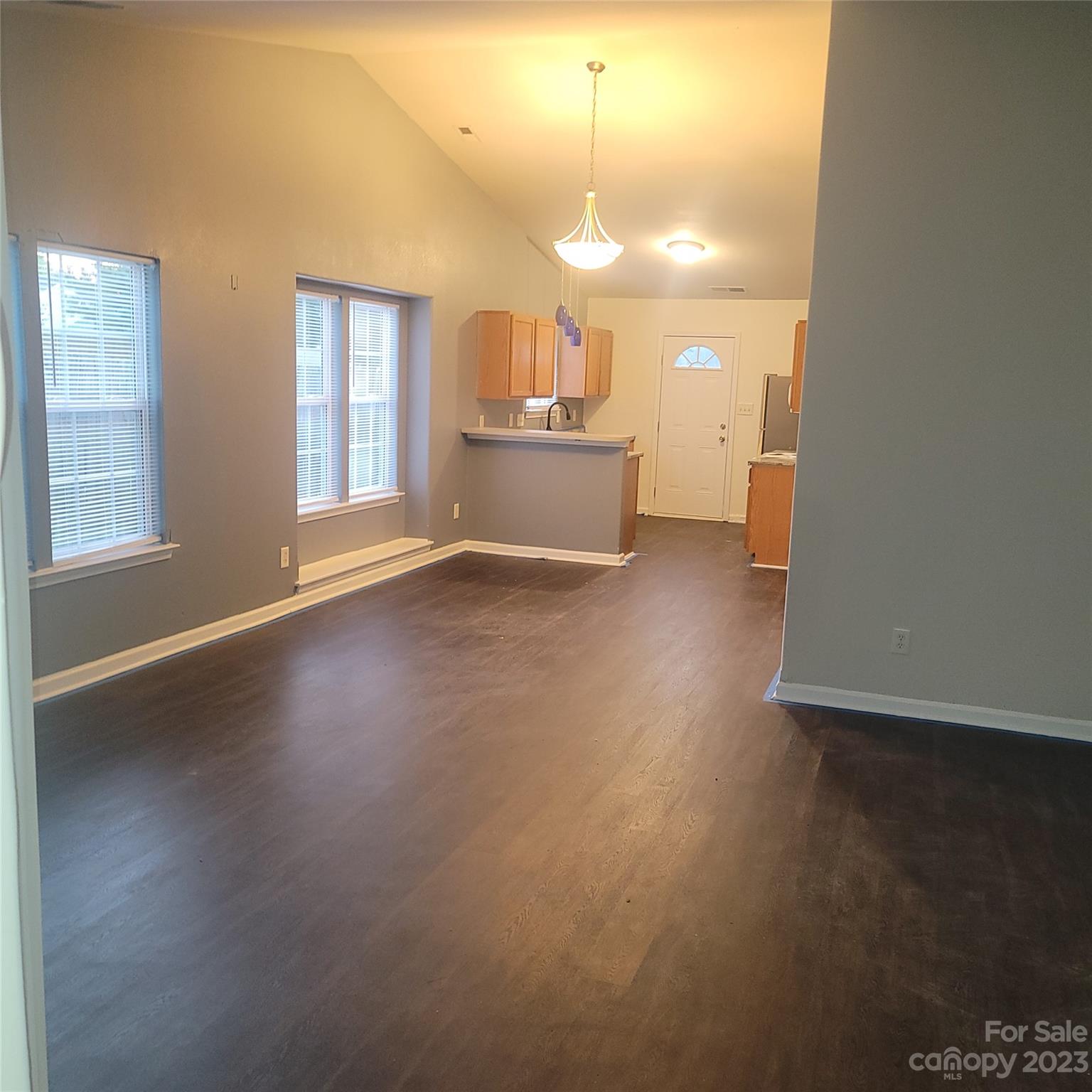 2865 Oasis Lane Charlotte, NC 28214 - Photo 2 of 15 an empty room with wooden floor and windows