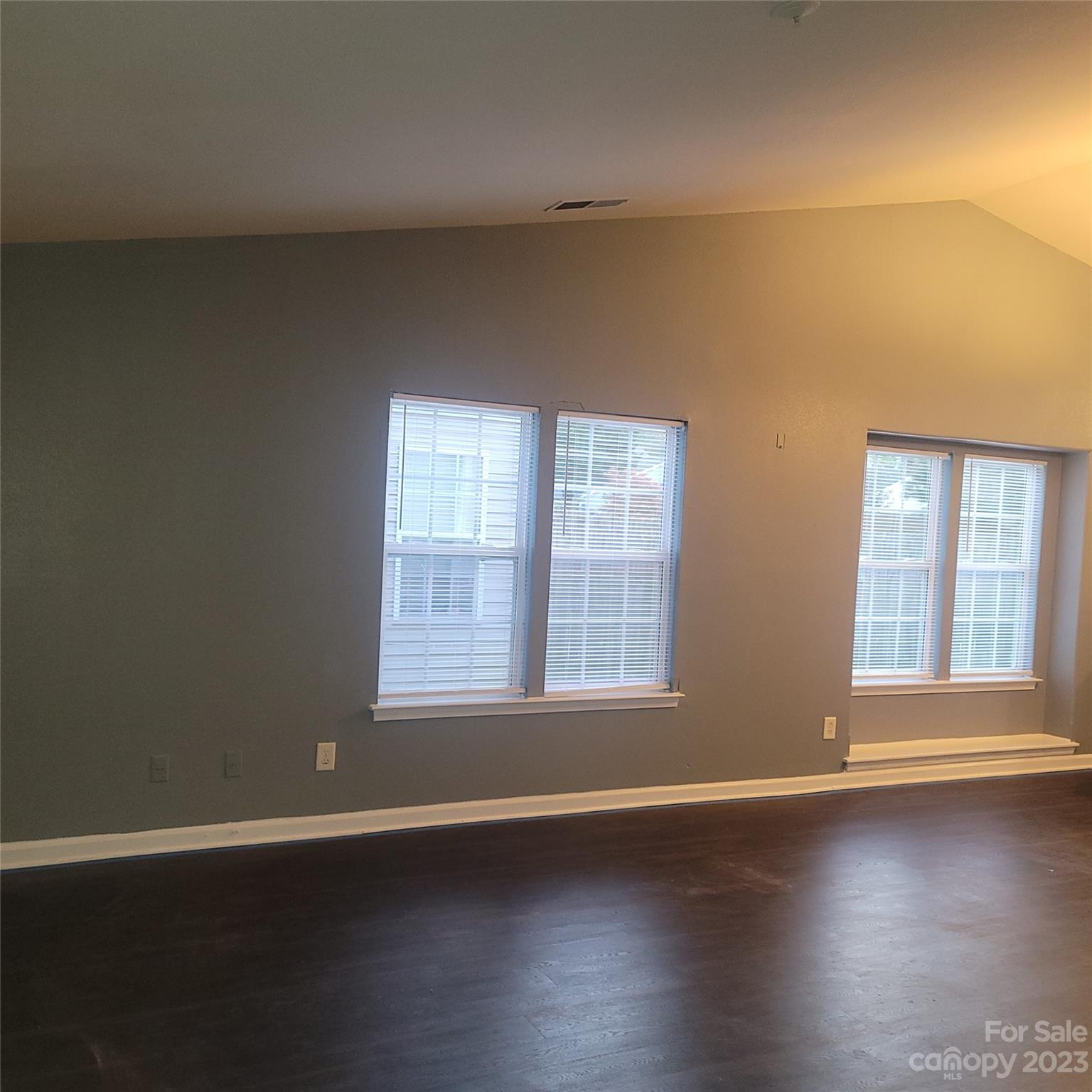 2865 Oasis Lane Charlotte, NC 28214 - Photo 4 of 15 an empty room with wooden floor and windows