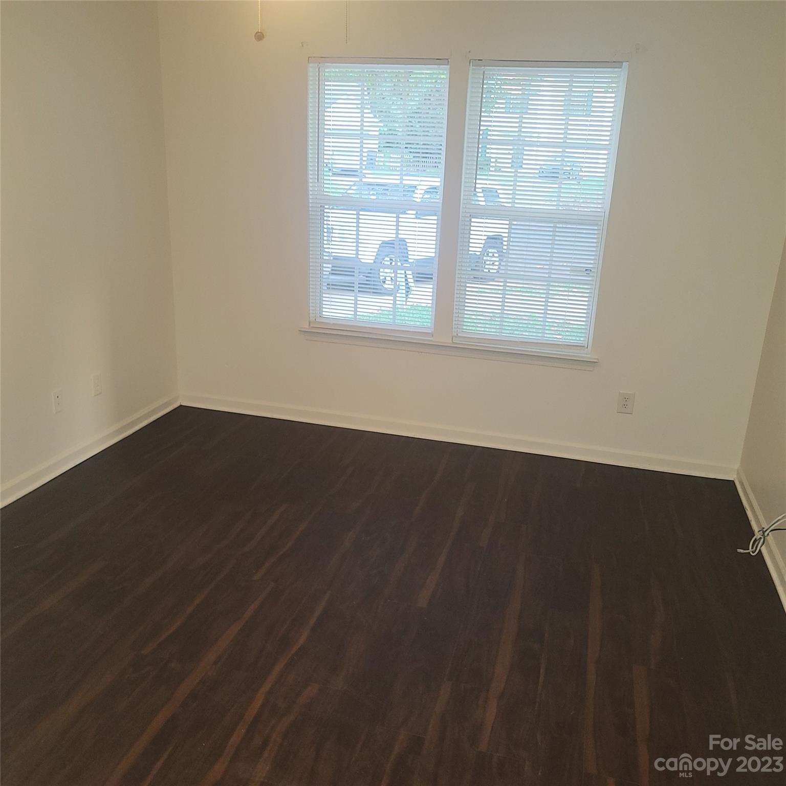 2865 Oasis Lane Charlotte, NC 28214 - Photo 7 of 15 an empty room with wooden floor and windows