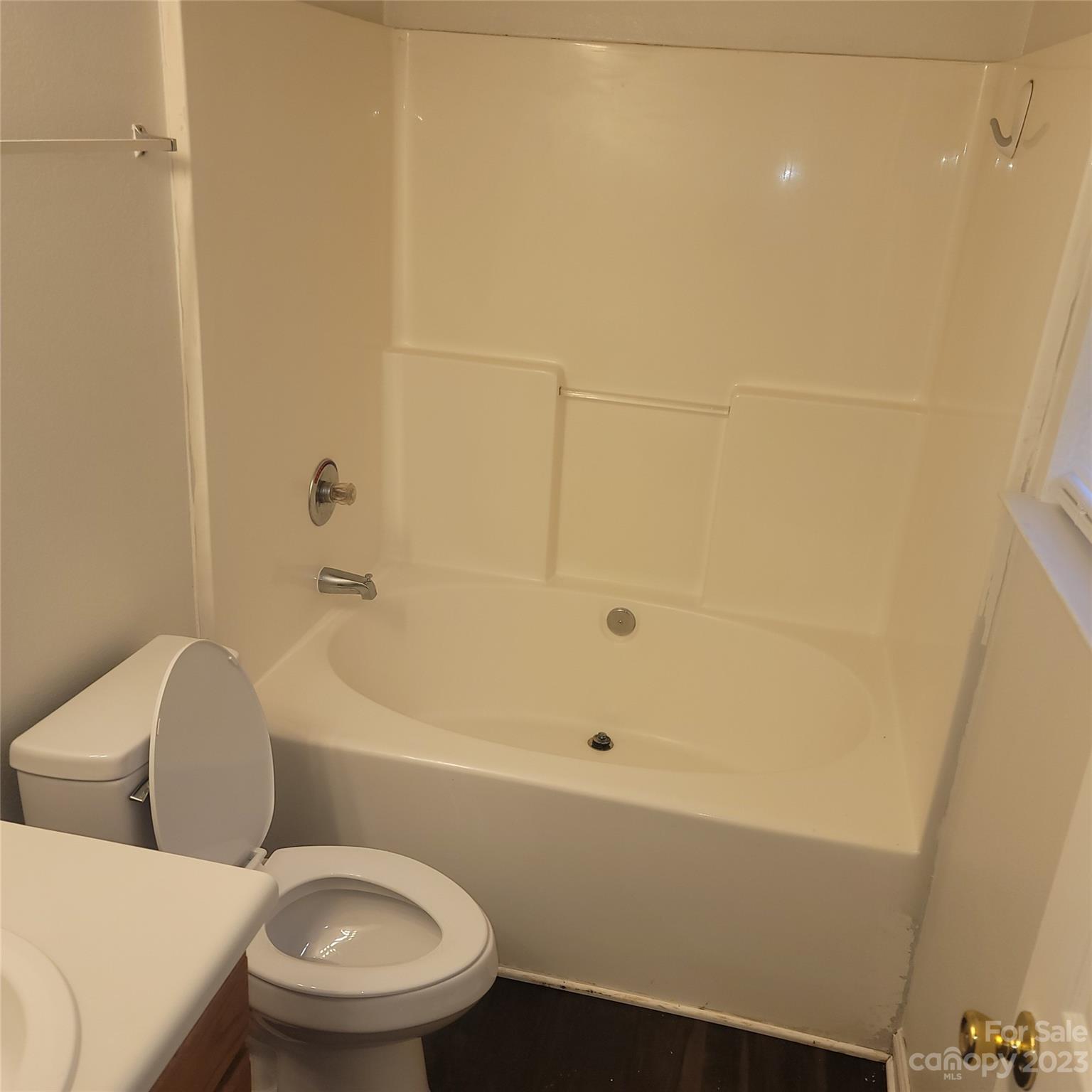 2865 Oasis Lane Charlotte, NC 28214 - Photo 10 of 15 a white toilet and tub sitting next to a bathroom sink