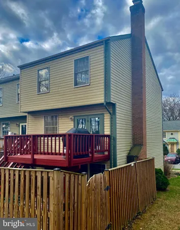 a view of a wooden house and a yard