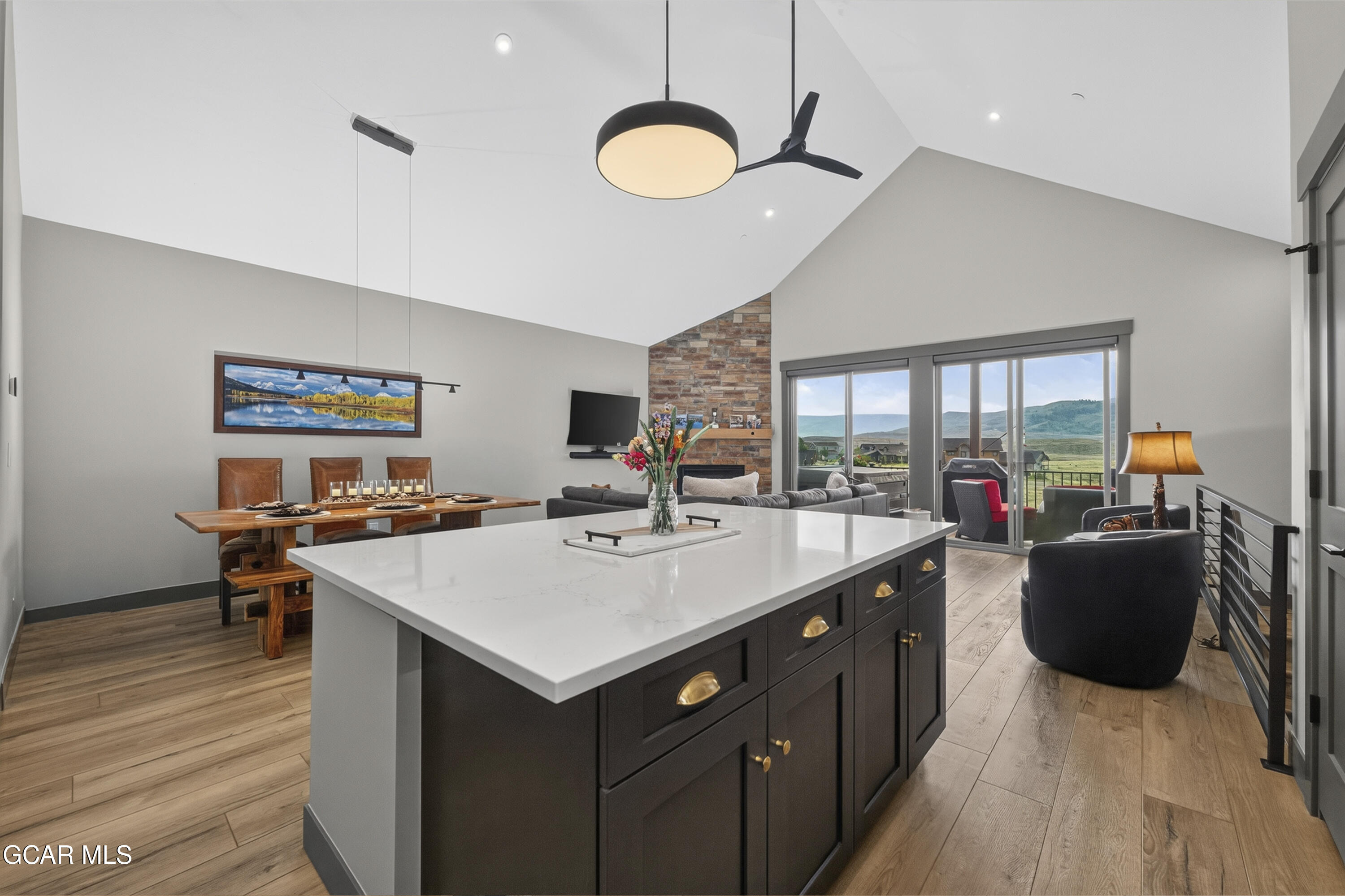 154 Eagle Ridge Drive Granby, CO 80446 - Photo 18 of 59 a living room with stainless steel appliances granite countertop a sink dishwasher a stove and a dining table with wooden floor