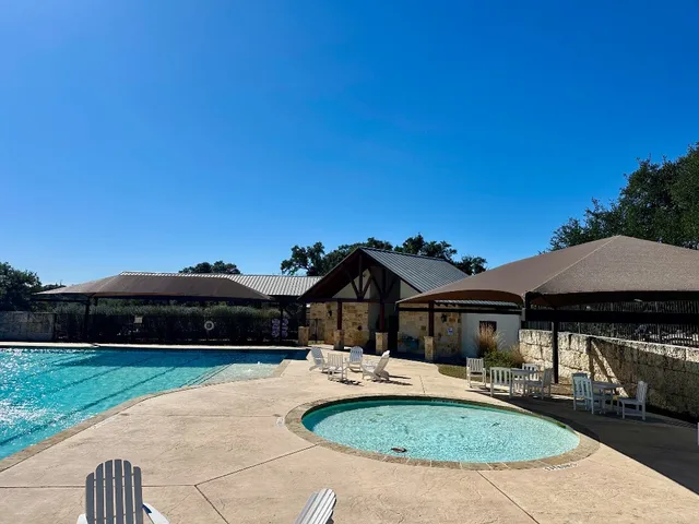 a view of house with backyard and outdoor seating