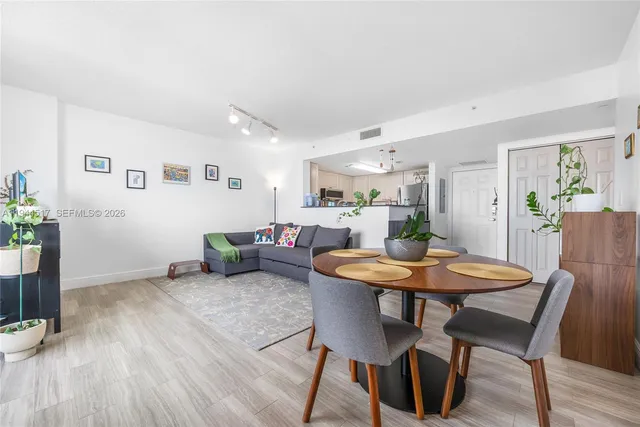a view of a dining room with furniture and wooden floor