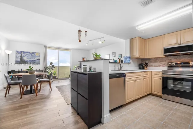 a kitchen with a sink cabinets and wooden floor