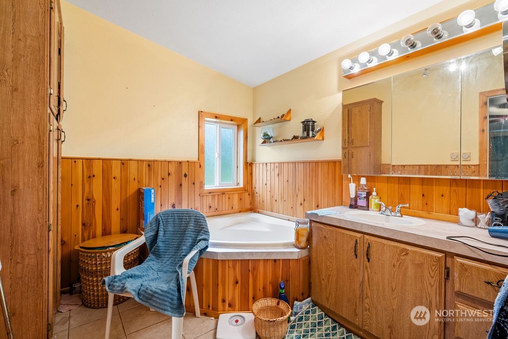 17043 Leitner Road Southwest Rochester, WA 98579 - Photo 11 of 18 a bathroom with a sink mirror and a bathtub