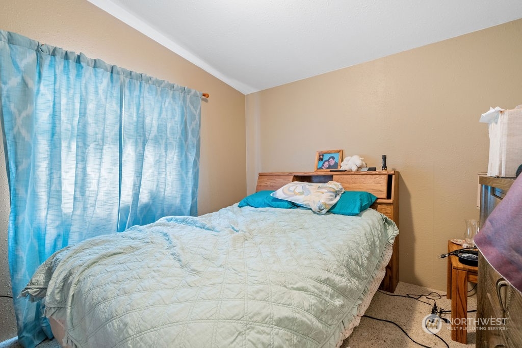 17043 Leitner Road Southwest Rochester, WA 98579 - Photo 13 of 18 a bedroom with a bed and wooden floor