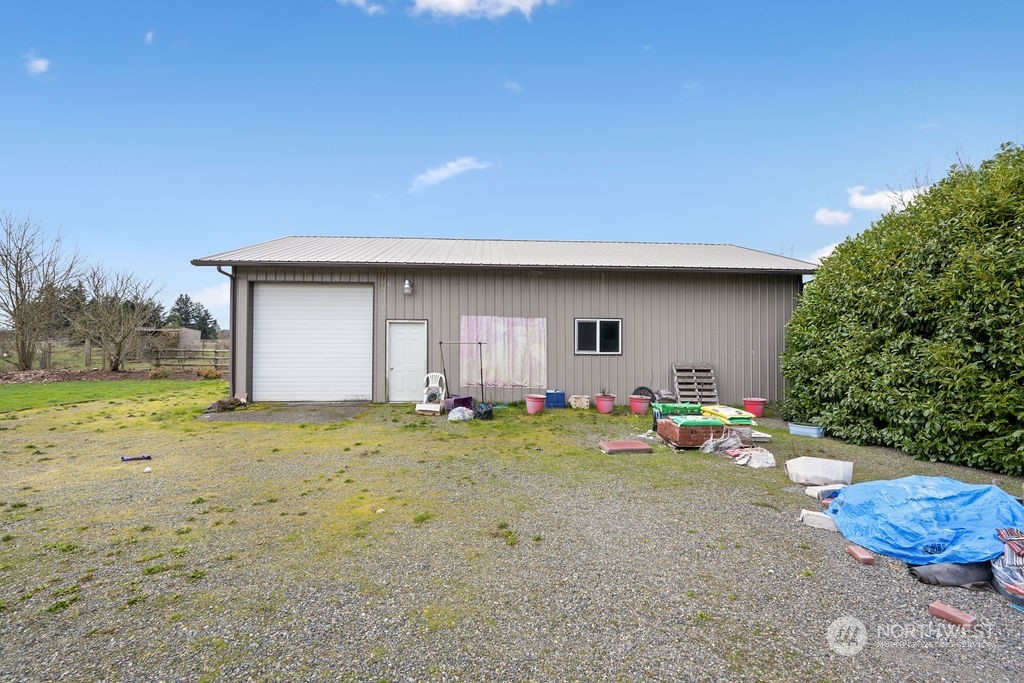 17043 Leitner Road Southwest Rochester, WA 98579 - Photo 16 of 18 a backyard of a house with table and chairs